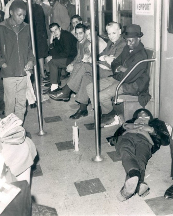 Blackout: Using a candle for a light passengers look at another passenger sleeping on the floor of a stalled subway train during power failure. November 10, 1965 (AP Wirephoto) 
