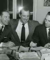 Indians pitcher Bob Feller (l) and catcher Jim Hegan (r) sit between GM Hank Greenberg as they sign their 1956 contracts - February 9, 1956