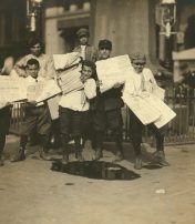 newsboys carry heavy loads at Park Row July 1910
