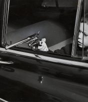 boy with toy gun pointed out of car window 1951
