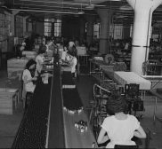 See What Products Were Produced In Major Cities Of The United States In 1939 Parke, Davis and Company, manufacturing chemists, Detroit, Michigan. Packaging of pills and tablets on a conveyor belt May 1943 photo Arthuir Siegel